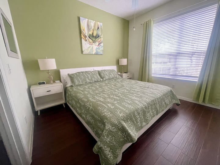 In second master bedroom, new blinds and room darkening shades. King-sized bed.