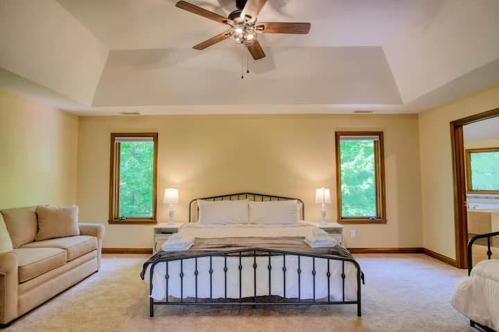 The master bedroom features 1 King sized bed, a day bed with a pull out trundle and a couch. 