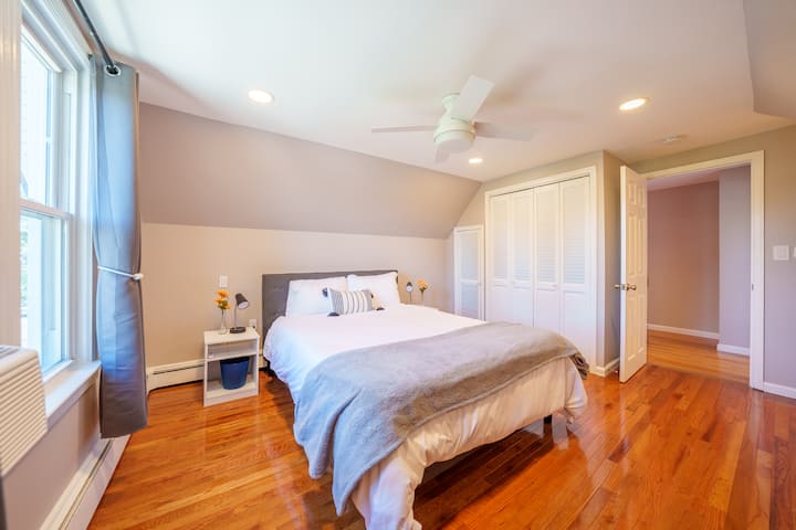 Master Bedroom (3rd Floor): Includes queen bed, fresh linens, 3 closets, ceiling fan, wooden dresser,  and window A/C unit.