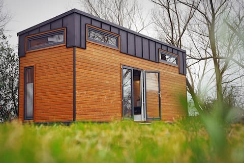 Tiny house between lakes, forest and meadows