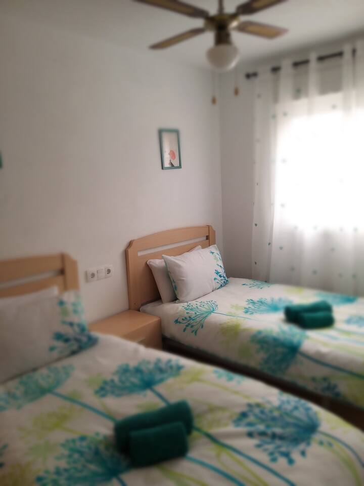 Dhoma e dytë e gjumit me 2 krevate tek, gardërobë e pajisur me hapësirë për tërheqje dhe varëse. Dërrasë për hekurosjen e hekurit.