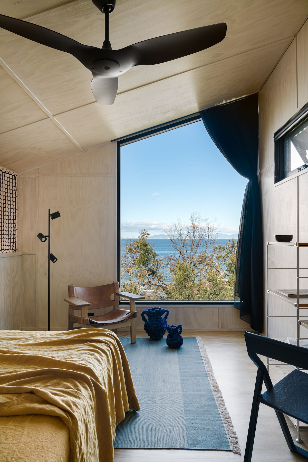 Main bedroom upstairs with feature window looking out to Wilsoms Prom.

(Please note, some specific interior objects included in the house may vary slightly to those shown in here)