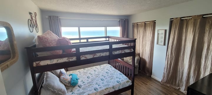 เตียงขนาดใหญ่ในห้องนอนที่สองพร้อมวิวชายหาด