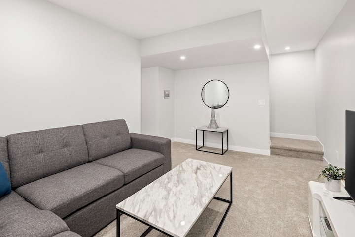 The basement second living room is the perfect place to relax and unwind. Features a sectional sofa bed thats converts to a full size bed, and a 55" Smart TV. 