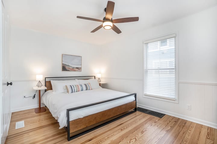 Main floor bedroom with king bed and walk-through the bathroom.