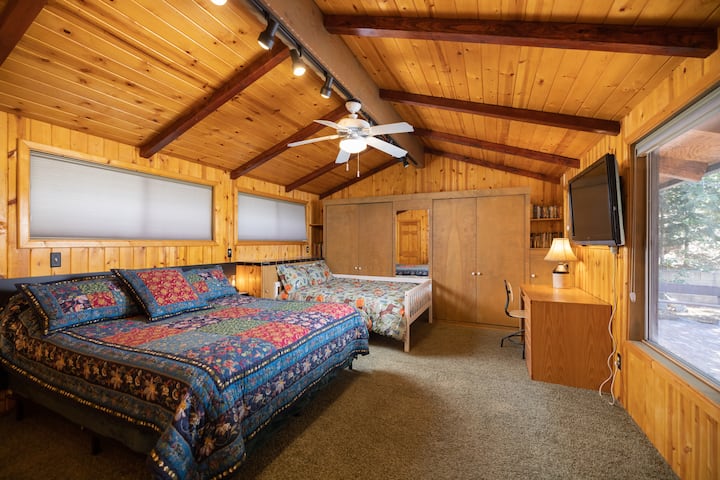 We call it the King Arthur Suite—the spacious main floor bedroom has two beds: an extra-comfy Cal King featuring memory foam, and a cozy double bed. Private work space desk, a Smart HD TV with Roku, en-suite bathroom, big dresser, luggage racks 