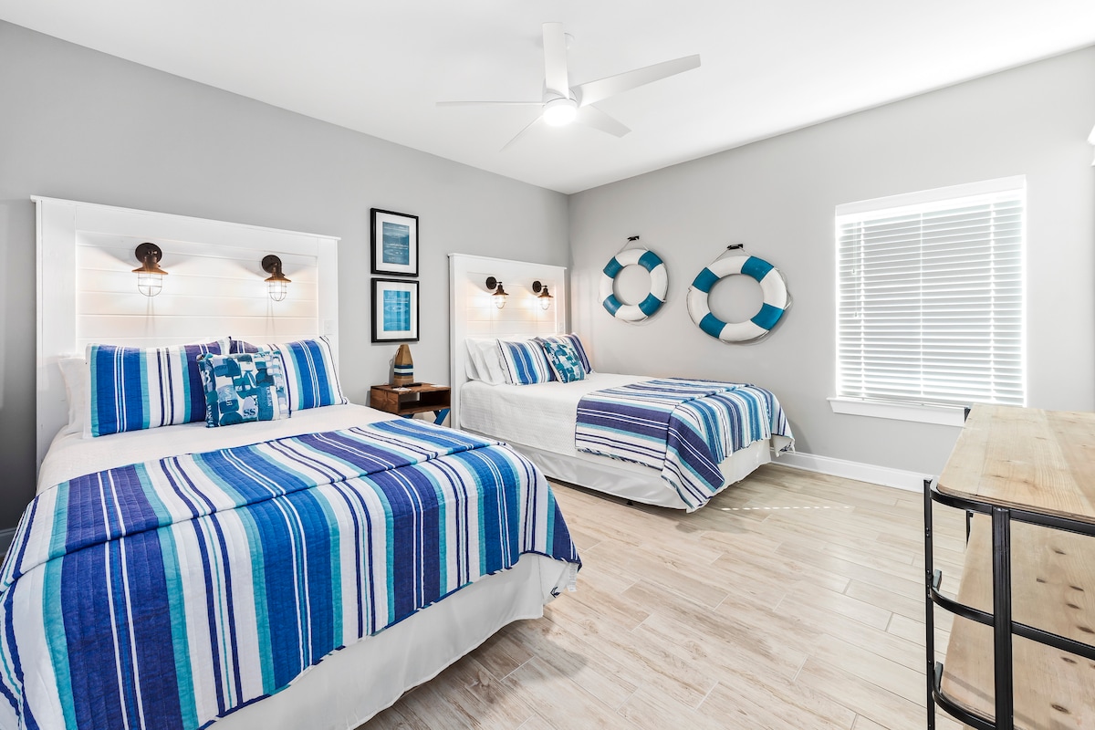 The upstairs lifeguard theme bedroom contains 2 queen beds and a 50" Smart TV. This large bedroom is perfect for 4 people and has a roomy walk-in closet.