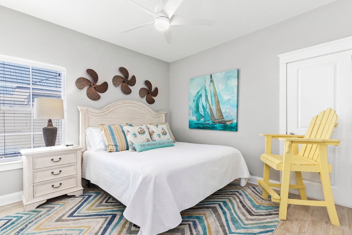 The upstairs boat theme king bedroom has a 50" Smart TV, lifeguard chair, nightstand and walk-in closet. 