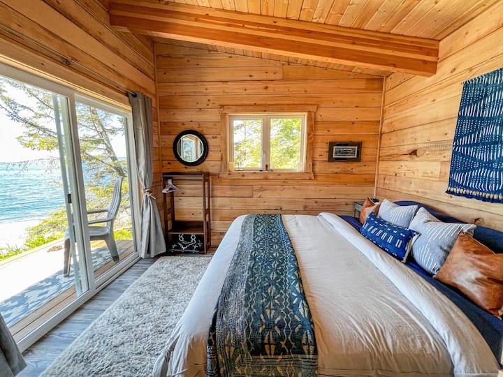 A king-sized bed fits perfectly in main floor bedroom and has an oceanfront balcony. A pocket door closes off this bedroom to the living area for privacy.