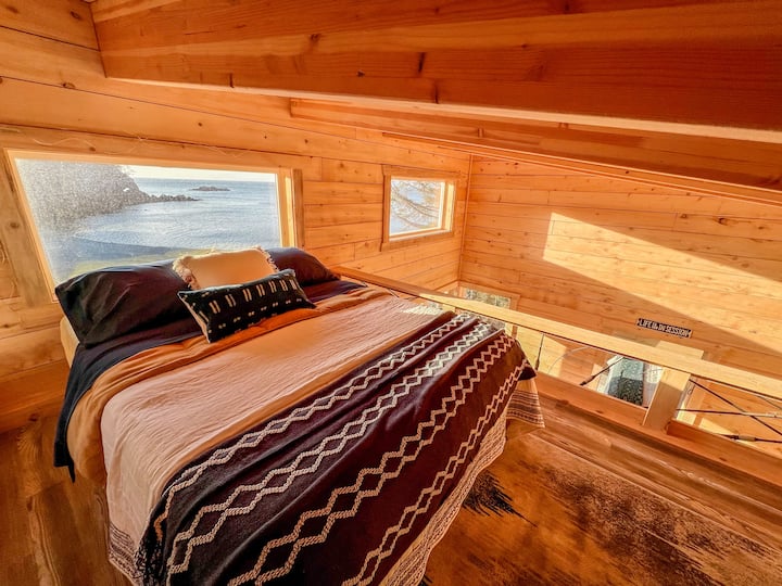 Upstairs loft double bed features a crow's nest view of the beach and Kachemak Bay.