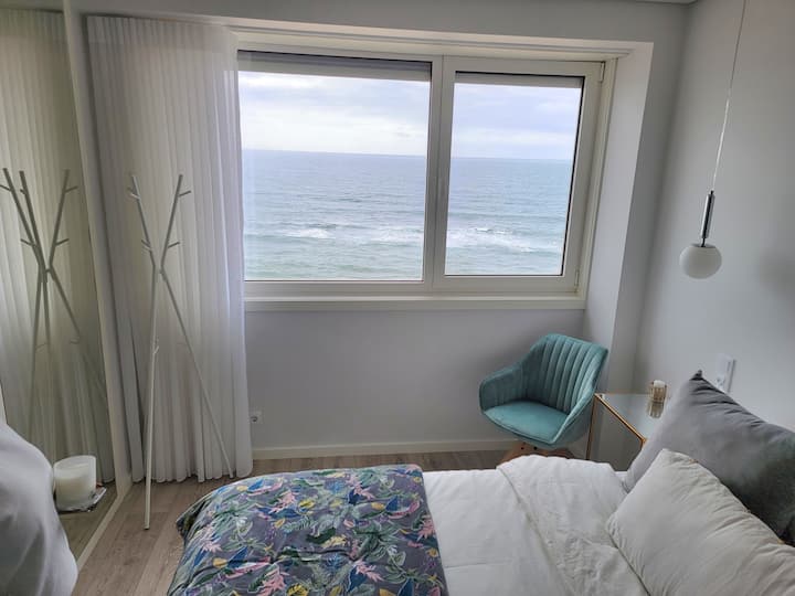 Main bedroom with beach and ocean views, ensuite bathroom