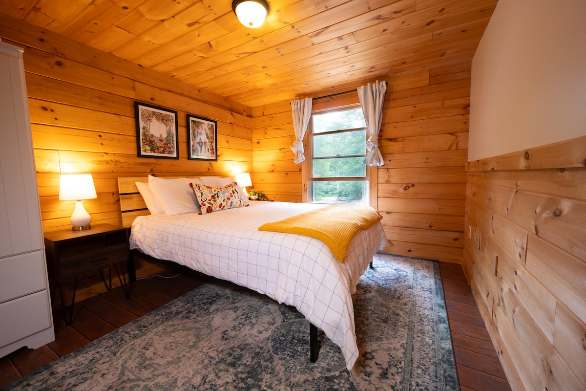 The main floor bedroom has a queen bed with Nectar memory foam mattress and a wardrobe.