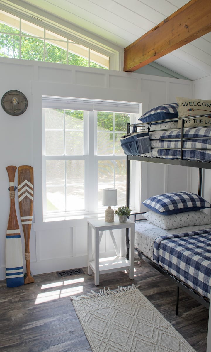 Perfect nautical bunk room for kids (or even adults!), vaulted ceiling with closet and luggage rack.