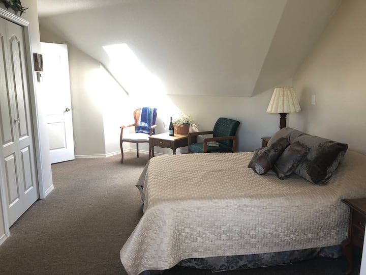 Large luxurious room overlooking ocean.  Has own half bath.  Shower across from room.  Dresser, closet, own thermostat.  On upper level.  Adjacent from large living room facing ocean.  Large smart TV, books, puzzles to enjoy. 