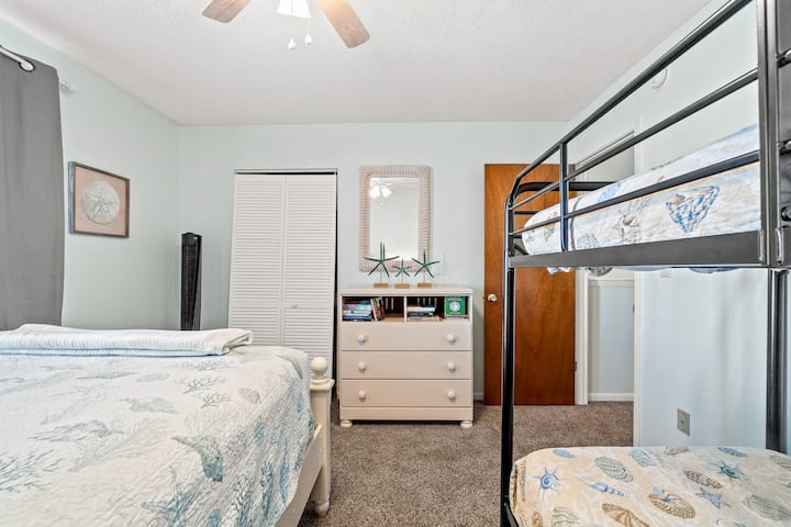 Bedroom 2 has a dresser and books to read on a rainy day