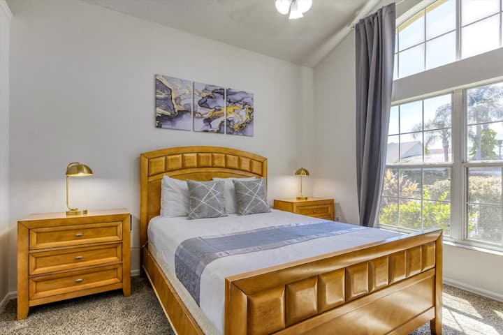 A spacious and open bedroom with a comfortable queen bed, vaulted ceiling and  large window for plenty of sunlight. Located on the first floor. All bedroom has it's own TV and Roku offering you access to your personal streaming accounts. 