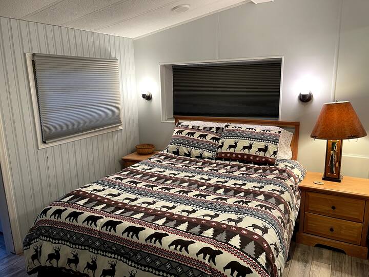 Master Bedroom on Main Floor off the kitchen with Queen Bed and Smart TV so you can access your own streaming services like Hulu and Netflix. 