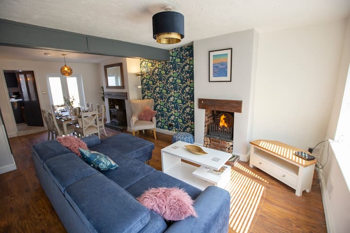 Enter from the front garden into the living space. The is a large comfortable sofa and warm cosy fire on chilly evenings.
A room perfect after a long walk exploring Moel Famau or Loggerheads