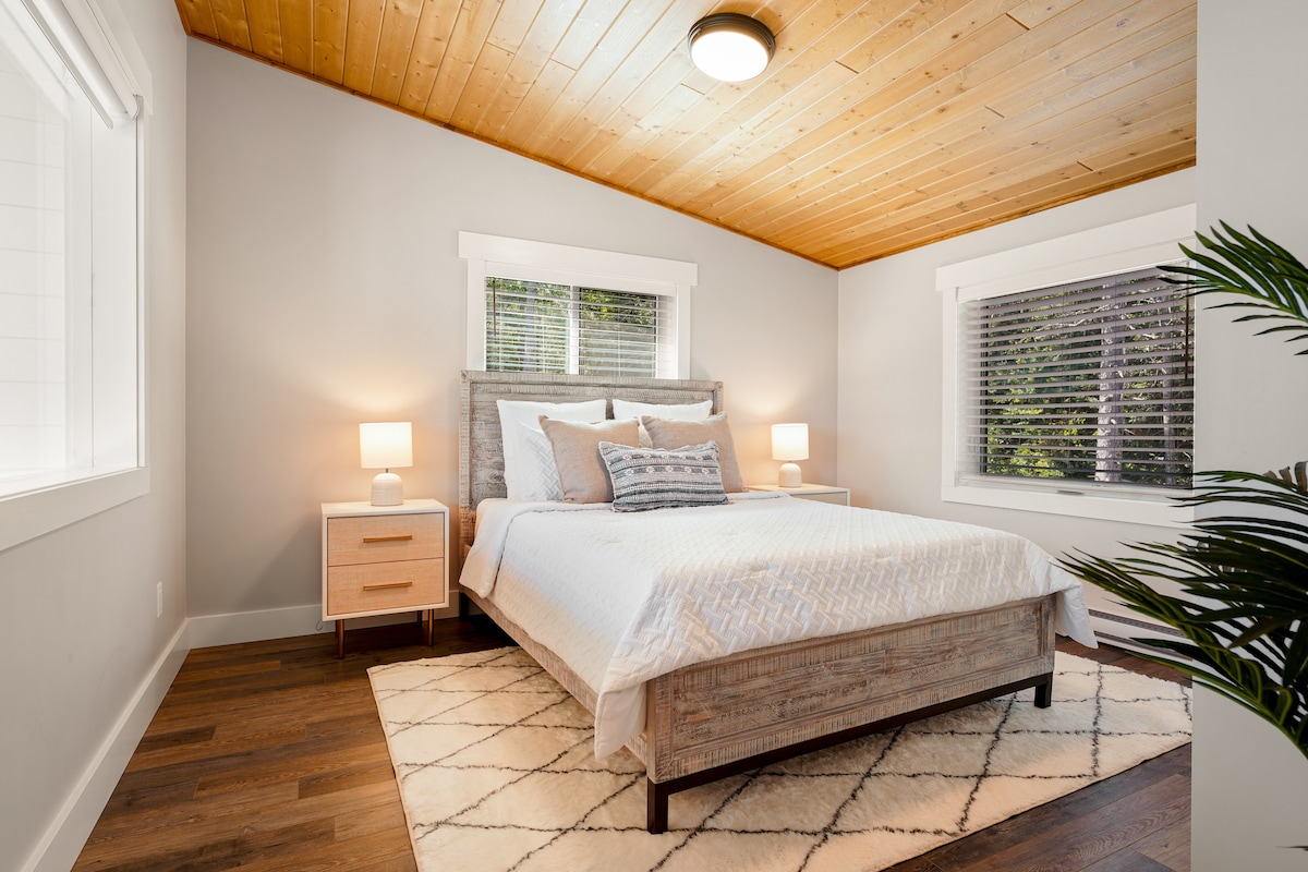 Upstairs bedroom with queen bed and smart TV