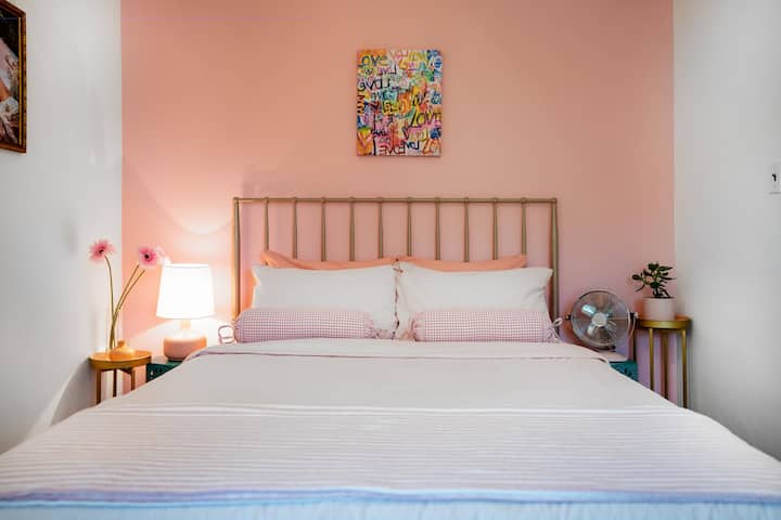 The pink room, with a medium firm memory foam queen bed.