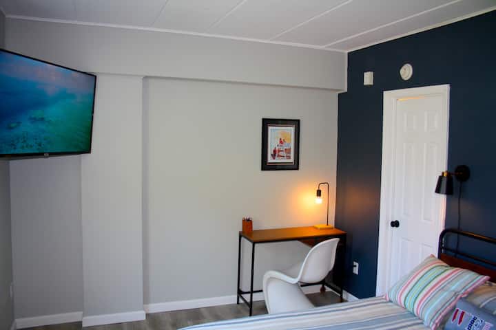 Relax in the cozy bedroom and enjoy entertainment on the 50-inch smart TV with streaming and live channels; comfortable seating and ambient lighting create a perfect retreat for unwinding after exploring Cape May.