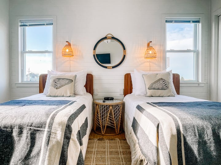 Guestroom with two twin beds and private reading nook.