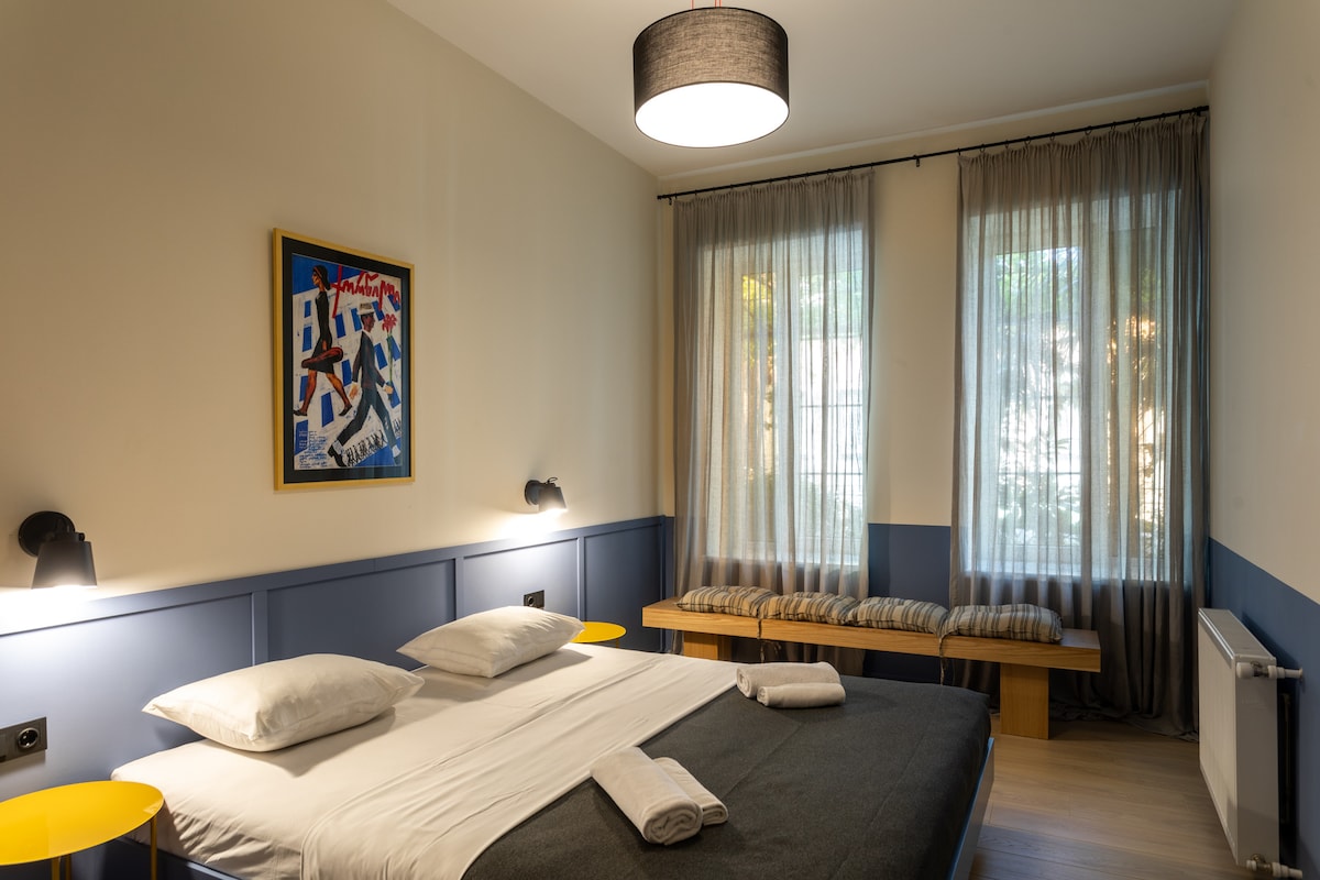 Cozy double bed is dressed in crisp, fresh linens, ensuring maximum comfort