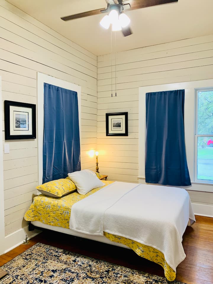 Front bedroom features a queen tempurpedic bed, lots of windows and a door connecting to the front porch.

All bedrooms feature blackout/thermal curtains for perfect sleeping conditions.