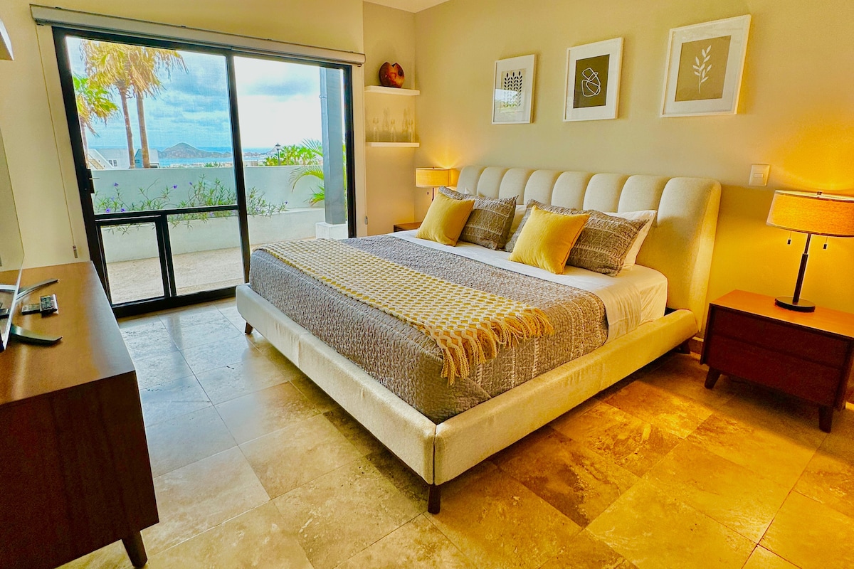 A roomy and relaxing Master Bedroom with a comfy king-sized bed, a big-screen TV, and an amazing view!