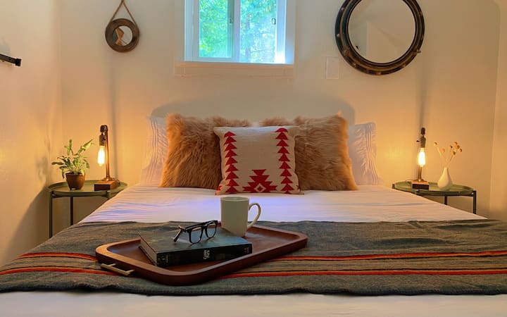 The upstairs loft with the "camping by the lake" vibe includes a queen size bed