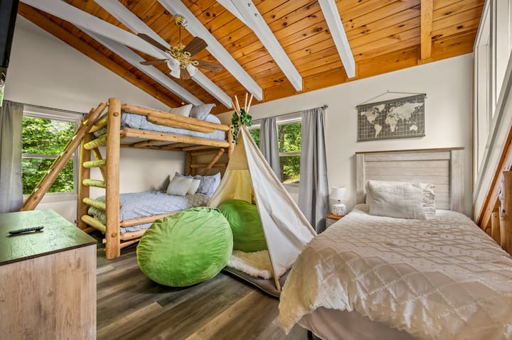 Awesome kids room!!
Full-over-full bunk beds and a twin bed.
And best of all, bean bag chairs!!
Kids will have a blast “camping” in here… 