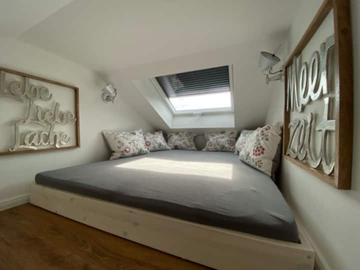 The attic sleeping loft with skylight and electric outdoor blinds 