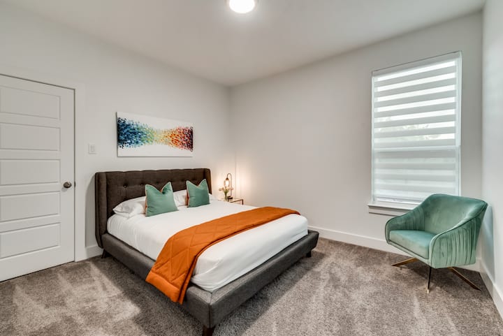 Upstairs bedroom #2 with queen bed and velvet armchair!