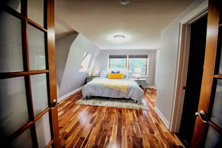 Come up and relax in the upstairs King-Sized Guest Bedroom with TV.