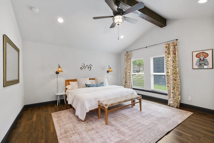 The primary bedroom has tons of space, great natural light, an en-suite full bathroom, a king sized Tuft and Needle mattress and direct access to the backyard.