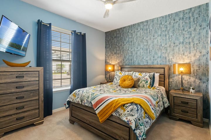 Downstairs bedroom featuring a queen bed. 