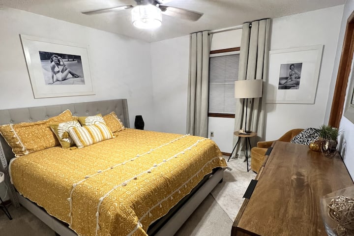 Dive into comfort in Bedroom 1! Check out the black and white beach babes from the '50s. Sleep soundly in the king bed, and don't forget to strike a pose at the large dresser mirror before heading out to explore! 