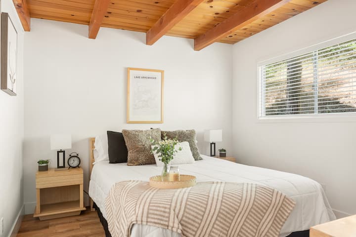 Bedroom 1, unwind in this cozy cabin bedroom, where rustic allure meets modern comforts. 