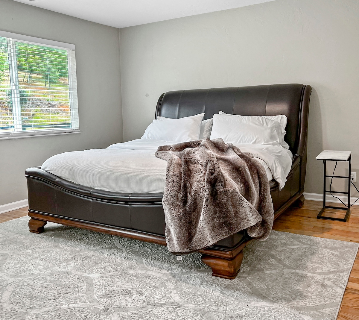 The master bedroom features a serene space with a closet (stocked with hangers) and ensuite bathroom