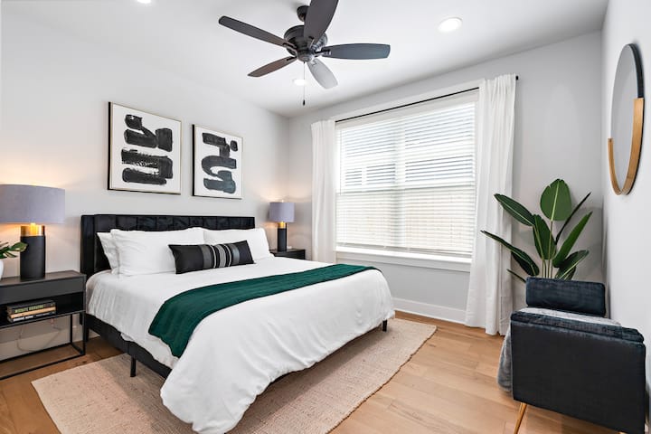 This master bedroom has a very comfortable king bed, decorated beautifully, with a bench for seating and a wall mirror for extra space to get ready. 

I look at this room and feel thankful you can't tell I didn't iron these curtains. :)