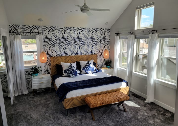 Sunny, master bedroom with Sleep Number King Bed, in-room coffee station, and ensuite bathroom.