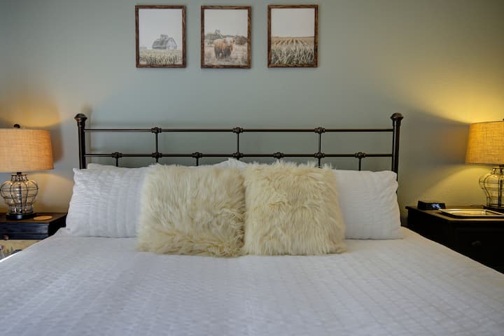 Eastern king hybrid gel memory foam mattress and Serta 4" pillow-top and memory foam topper.   Dresser.

Room has a portable heater and extra blanket on the bed and in the closet.