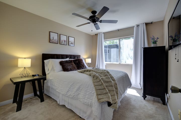 Cozy bedroom with a plush queen mattress, upgraded with a Serta 4" pillow-top and memory foam topper. Includes 45" Samsung Smart TV, dresser, portable heat dish, and extra blankets. 