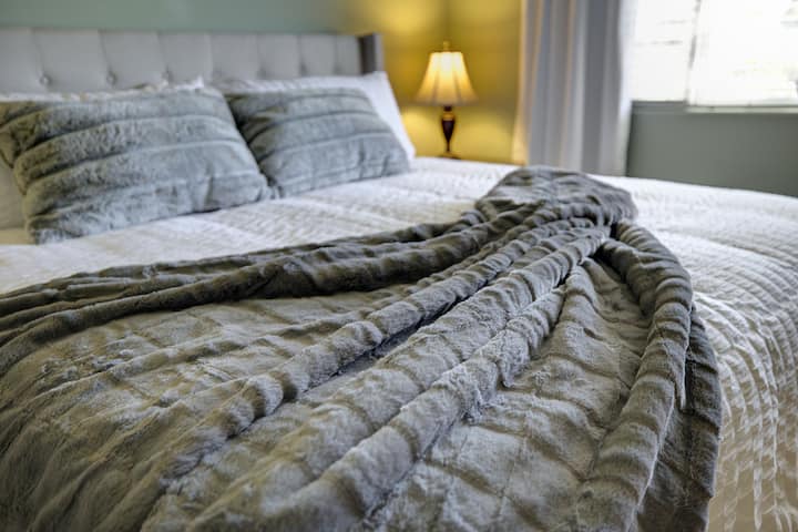 Spacious master suite with King medium plush mattress. Features ceiling fan, large dresser, and 55" Samsung Smart TV. Ideal for couples or families seeking a relaxing Oceanside vacation rental near beaches, Legoland, & attractions in San Diego.