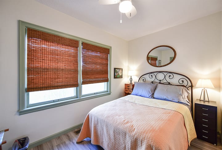 This bedroom features a full size bed and a walk in closet.