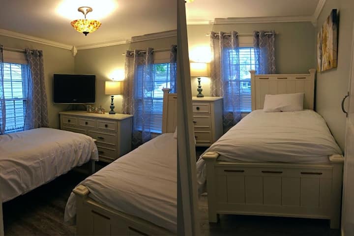 On the left: TV and twin beds in the second bedroom 
On the right: a full view of one of the two twin beds in the second bedroom