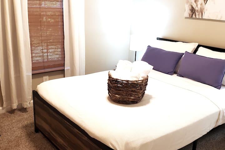 Adorable full bedroom to relax with a wicker chair and spacious closet. USB lamp ports for your convenience.