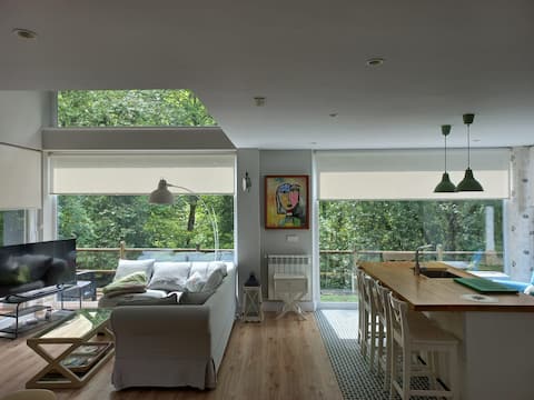 House with forest and river in a town with a soul