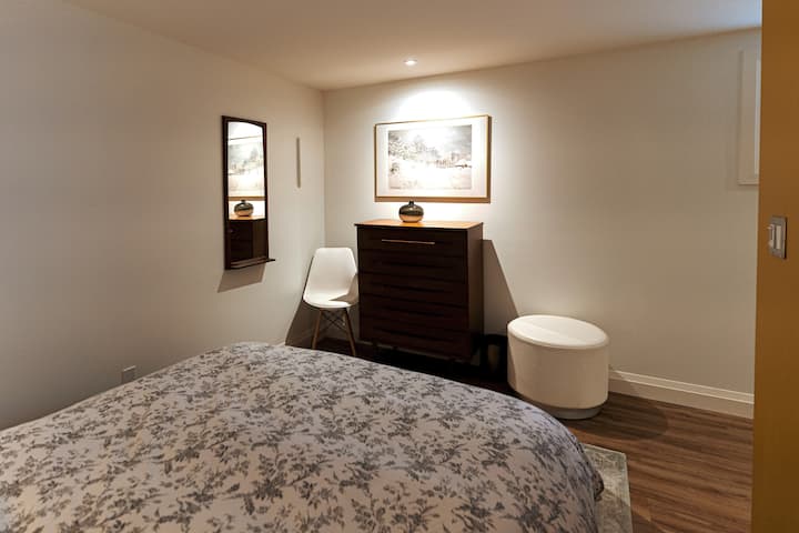Queen sleeping alcove  with dresser and flip down wall hanger rack.