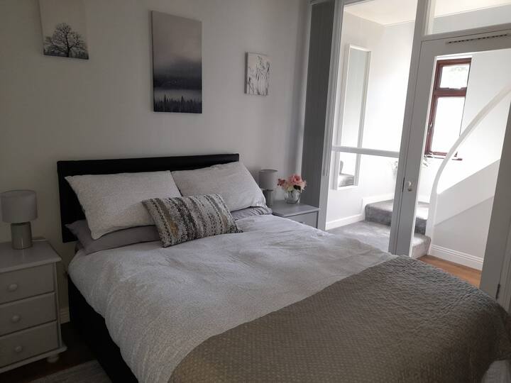 Downstairs bedroom adjacent to large bathroom with shower. Comfortable double bed complete with wardrobe and chest of drawers. Wooden floor with rugs. Adjacent to bathroom. 
